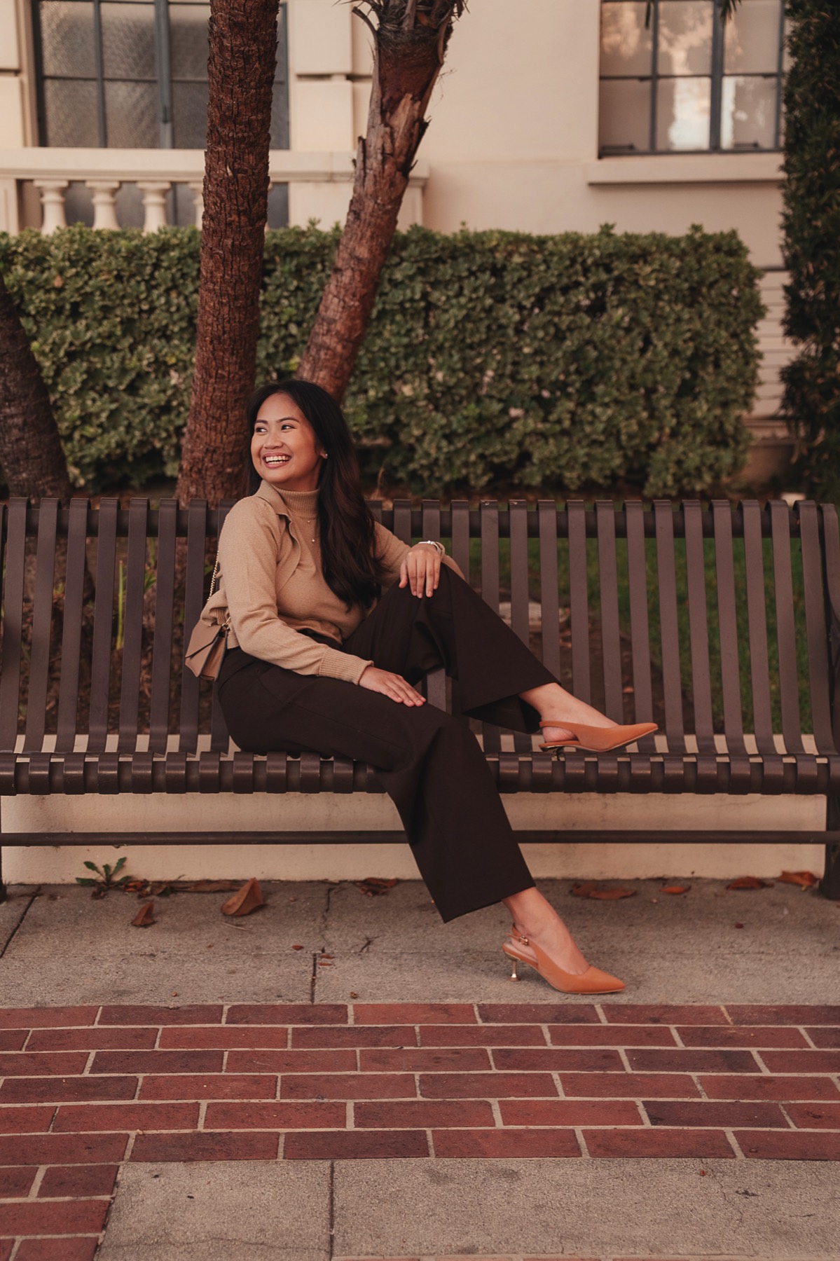Denise Chicano smiling on a park bench